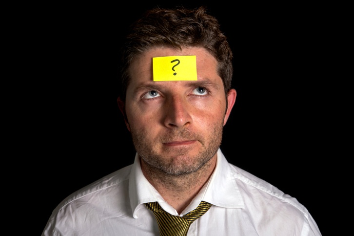 Image of a man with a sticky note on his forehead